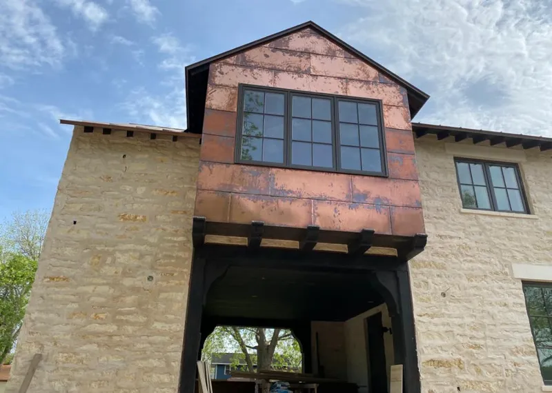 Copper metal panel facade on a stone building for Skylight Installation in Laurens